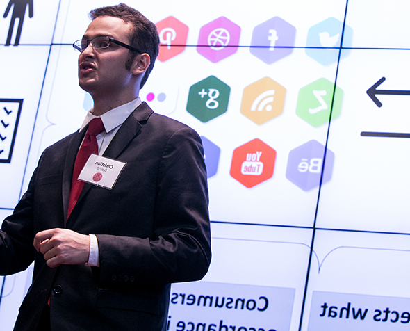 Male student in a suit presenting at the Race and Case business competition